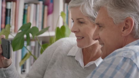 happy-old-couple-having-video-chat-using-smartphone-waving-at-grandchildren-enjoying-chatting-to-family-on-mobile-phone-sharing-lifestyle-relaxing-at-home-on-retirement-4k