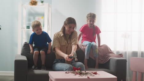 young-mother-with-children-breaks-piggy-bank