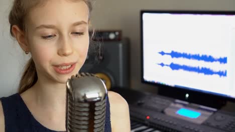 little girl singing a song in home recording studio.