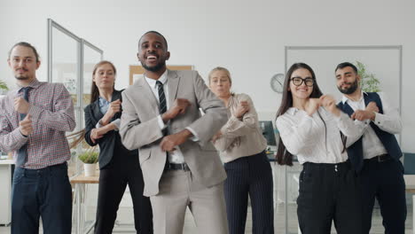 happy business team dancing in office