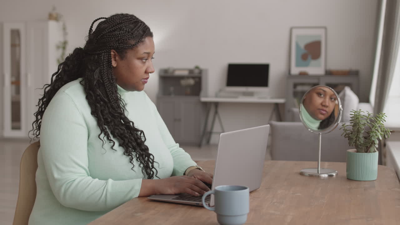 Young African Businesswoman Working on Computer
