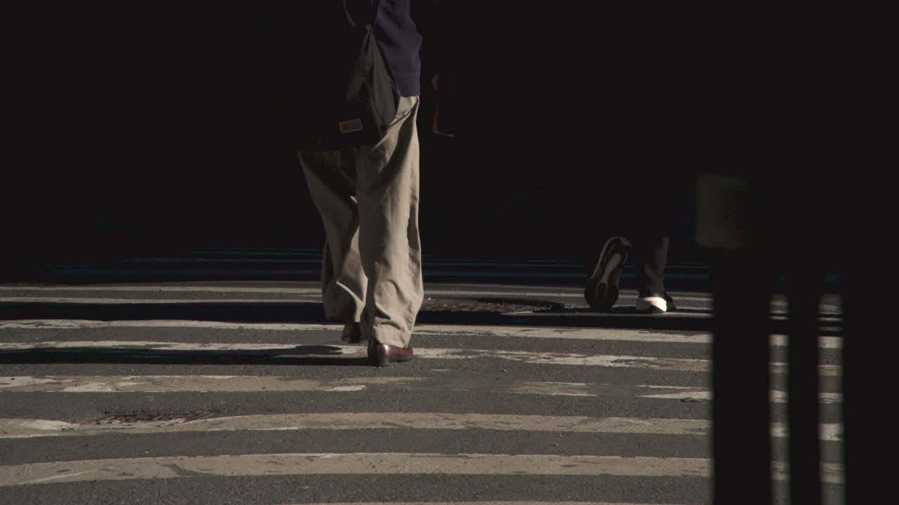 Slow motion shot of feet in a city crosswalk. Shot at sunrise in Manhattan