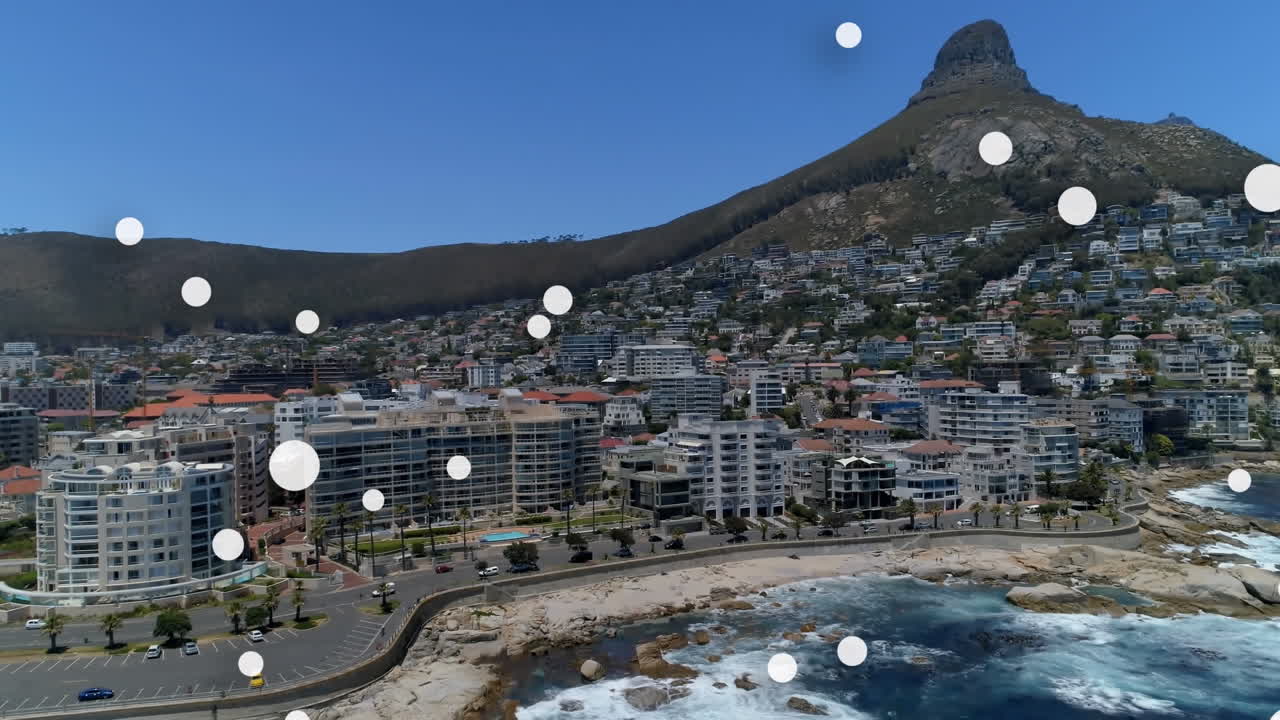 composición digital de múltiples manchas blancas flotando contra la vista aérea del paisaje urbano