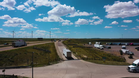 aerial rising shot overlooking trucks heading to the american freeway in sunny usa