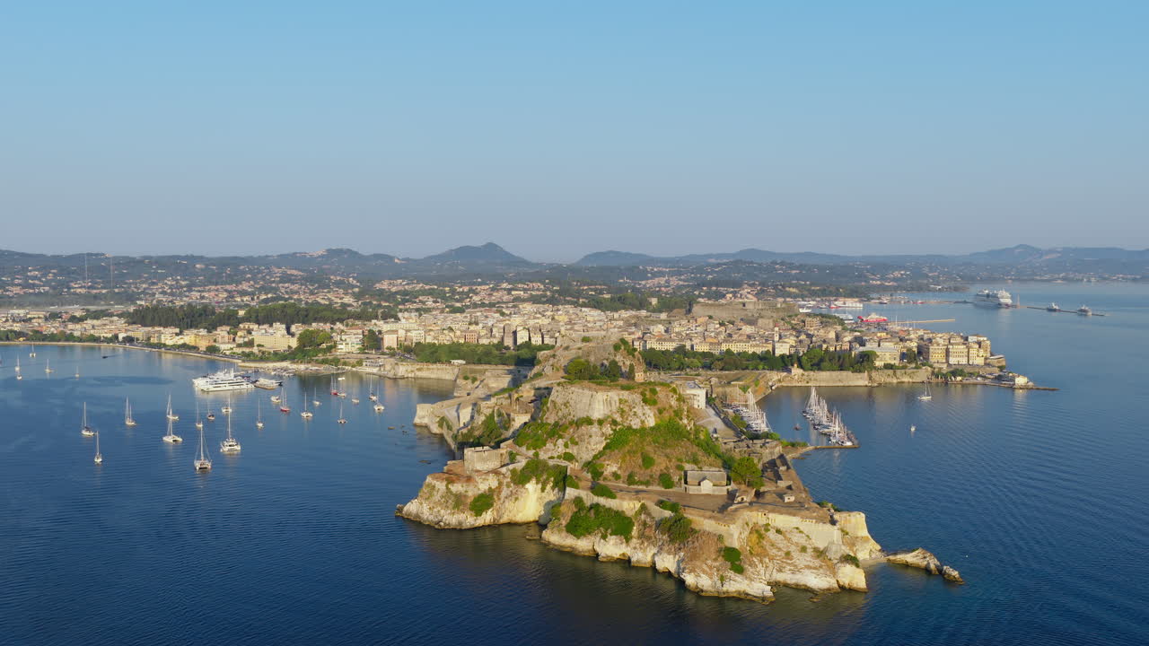 Drone flying above The Old Fortress of Corfu during sunrise, Corfu yacht harbour, Ionian Sea, Drone shot, Establishing