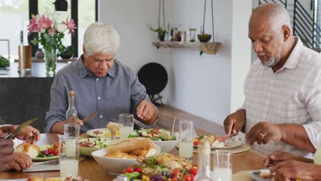 Happy-senior-diverse-people-having-dinner-at-retirement-home