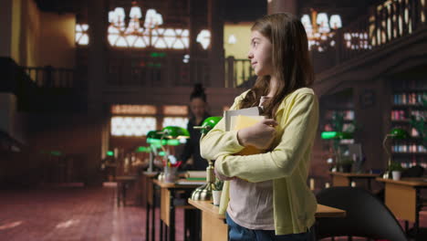 girl in a library holding books