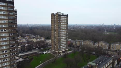 drone shot flying quickly towards a high rise apartment block in london