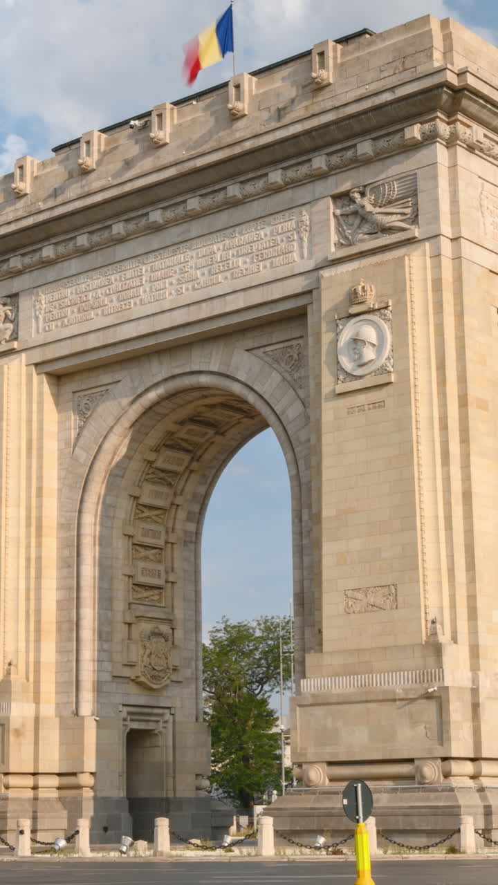 Time lapse of cars moving near the Triumphal Arch of Bucharest, Romania. Vertical