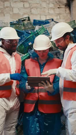 recycling workers inspecting waste materials