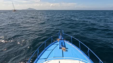 a boat travels through the ocean near phuket, thailand, under clear skies with gentle waves and bright sunlight