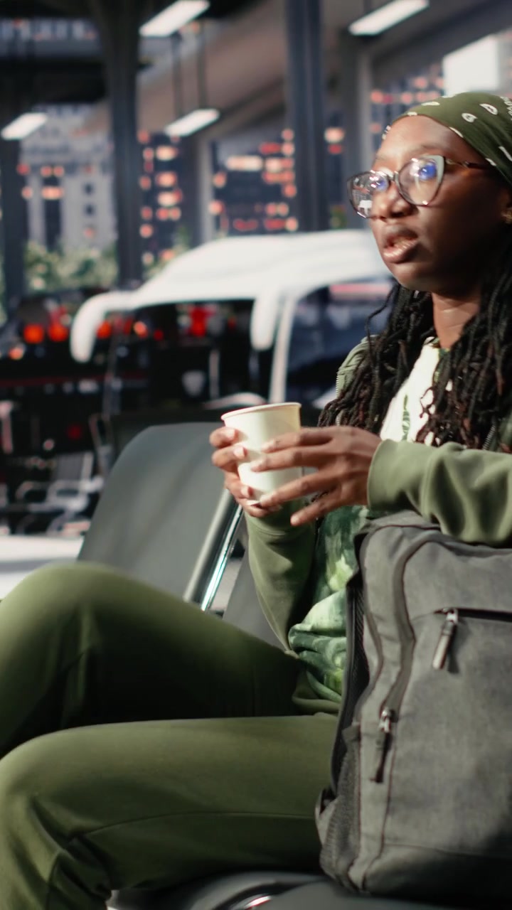 Young Woman Sitting in Airport Terminal Waiting Area