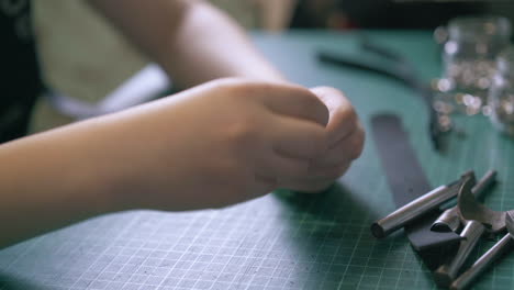 professional tailor sets buckle into black leather belt