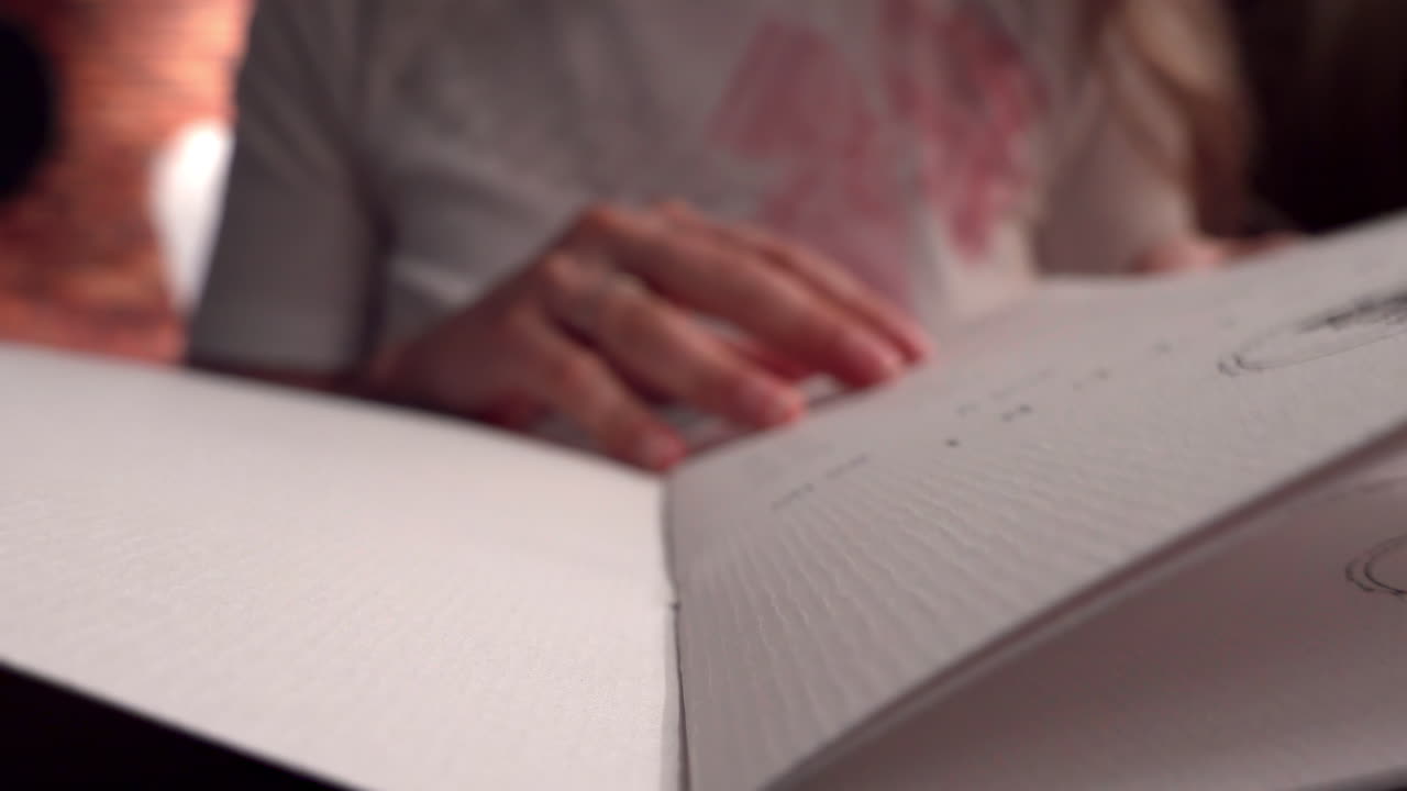 Close up of a woman reading a menu at a restaurant