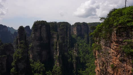 sandstone pillars covered with greenery in zhangjiajie national forest park, china. cloudy day