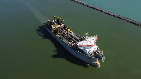 A-ship-full-of-containers-in-the-canal,-going-to-the-open-ocean