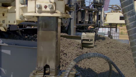 Industrial-machine-pushing-cement-material,-slow-motion-view