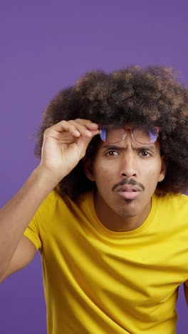 man with afro and glasses expressing various emotions