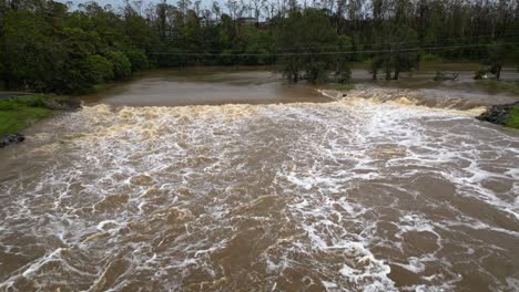 coomera, gold coast, 2 january 2024 - aerial view of coomera river causeway under flood waters from the 2024 storms in january