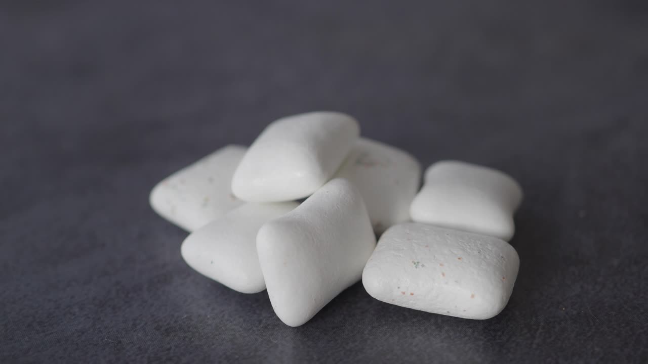 White Chewing Gum Pieces on Grey Background