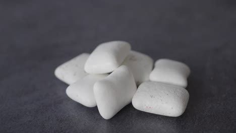white chewing gum pieces on grey background