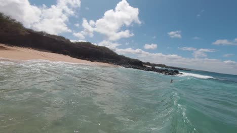 friends-enjoying-the-refreshing-green-sea-and-breathtaking-scenery-at-Maunaloa's-amazing-beach-in-Hawaii,-while-bonding-with-friends-in-a-sustainable-eco-tourism-paradise