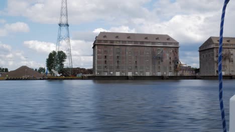 View Of Grain Terminal With Elevator On Nowy Port From A Boat Cruising On Martwa Wisla River In Gdansk, Poland. POV
