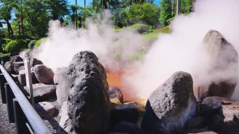 steam and red iron oxide mud pool from geothermal beppu, oita japan
