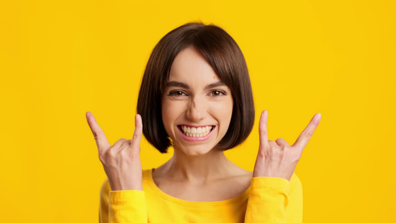 Happy Woman Making Rock and Roll Gesture