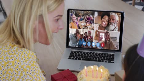 caucasian mother and daughter celebrating birthday on video conference on laptop at home