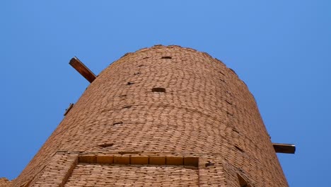 birds are flying near of the mausoleum of khoja ahmed yasawi in the city of turkestan.