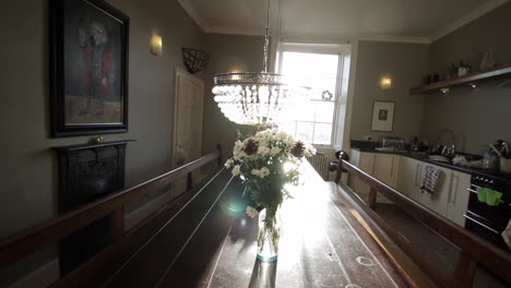 large kitchen banquet table with crystal pendant lights