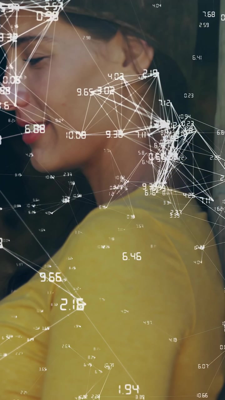 Vertical video: Woman uncrossing arms and turning to show profile while data overlaying yellow top