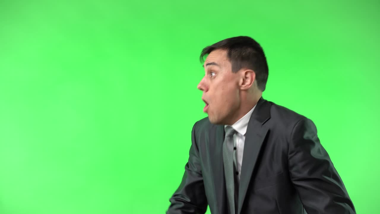 Businessman expressing surprise and shouting on green screen