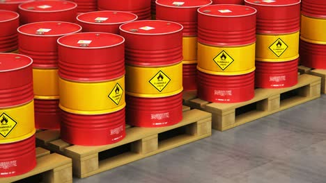 group of rows of red stacked oil drums in storage warehouse