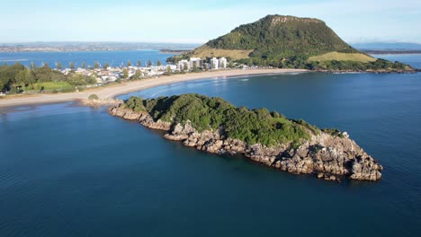 aerial view of a coastal town with a mountain and island