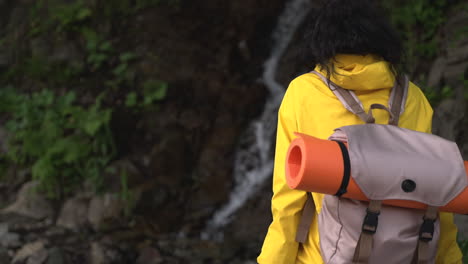 woman hiking near waterfall