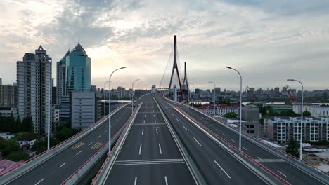 drone aerial view of traffic and highway in the city during sunset