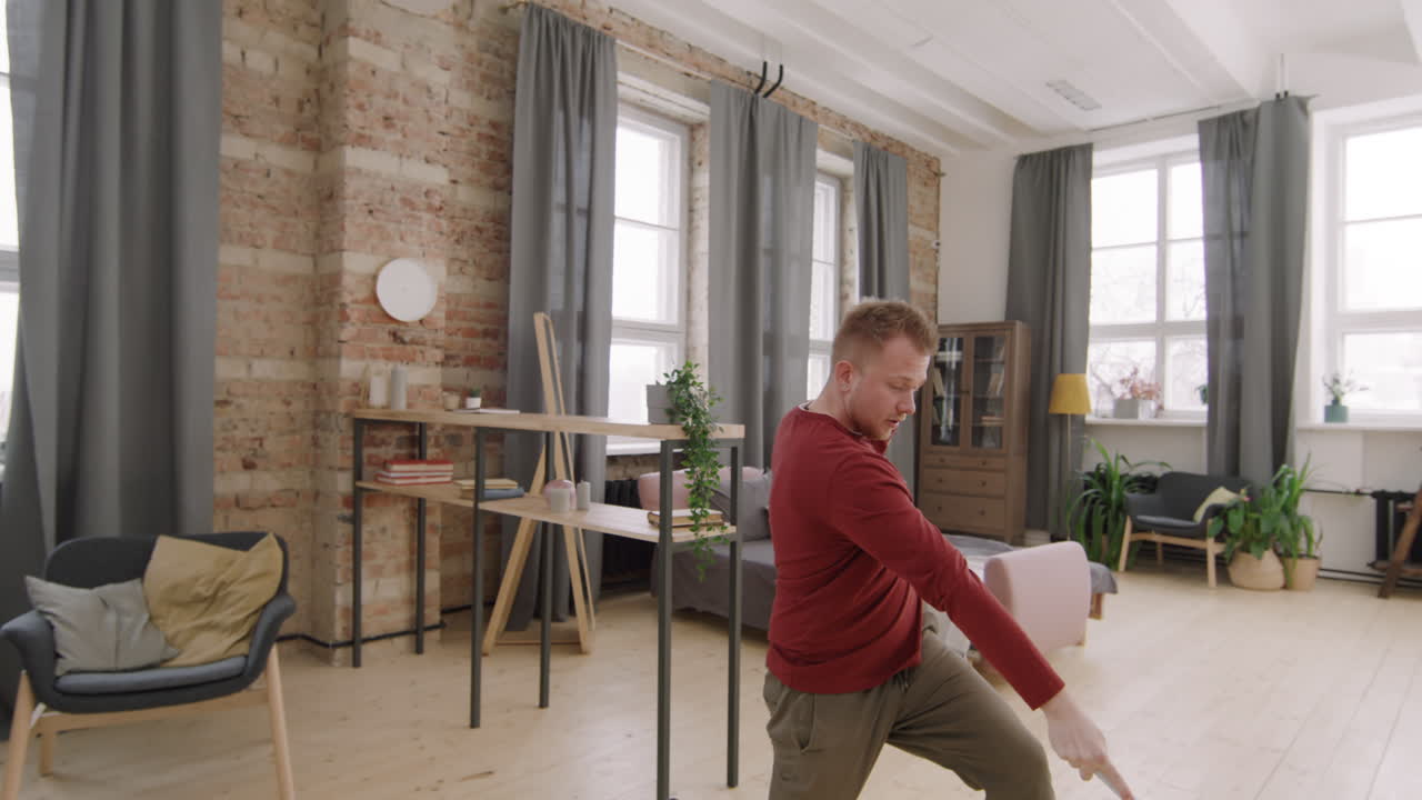 Carefree Man Mopping Floor and Dancing