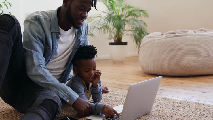 Vater und Sohn nutzen gemeinsam zu Hause Technologie