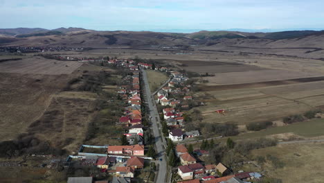 flying with drone over village area in winter