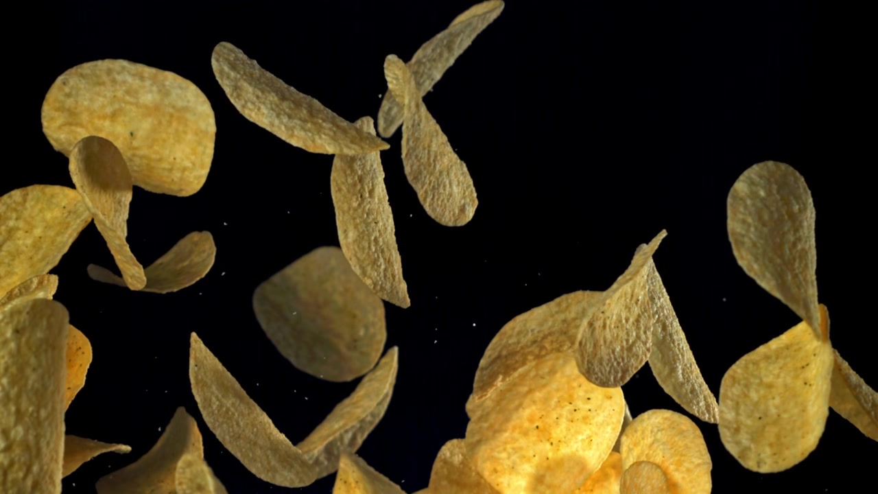 Crispy Potato Chips Floating Upwards in Slow Motion on Black Background