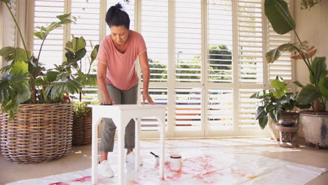 painting white table, woman focusing on diy home improvement project