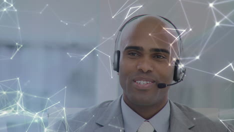 animation of network of connections over businessman with headset in office