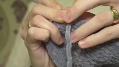 close-up crocheting with natural wool for the cold winter