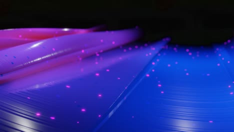abstract 3d surface with beautiful waves, luminous sparkles and bright color gradient blue purple. waves run on very shiny, glossy surface with glow glitter. 4k looped animation