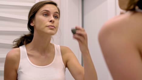 Woman-putting-on-her-make-up-in-bathroom