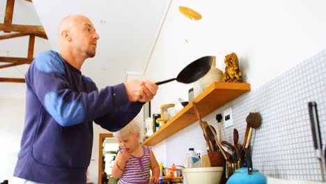 Father-preparing-pancake-in-kitchen-4k