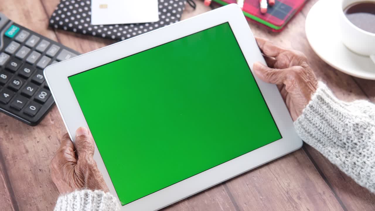 mujeres mayores trabajando en una tableta digital con pantalla verde
