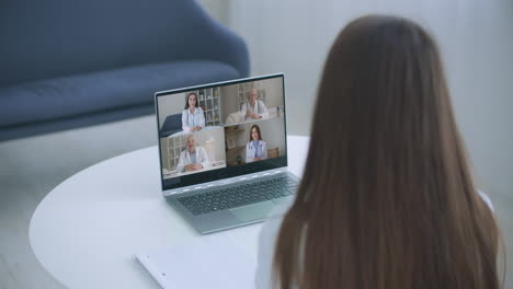 close up of young female talk on video call consult with diverse doctors colleagues woman patient have online consultation with gp or physicians medical nurse in webcam conference with coworkers